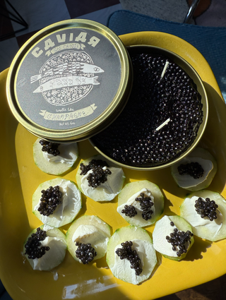 Champagne-scented caviar tin candle on a mirrored tray, novelty foodie gift — Wren Supply Co.