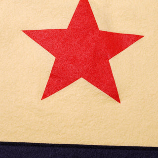 Oxford Pennant USA camp flag in cream, navy, and red hanging against a wall