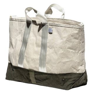 The tote seen from the front at an angle, showing the crumpled texture of the recycled fabric and the olive base band wrapping around the bottom