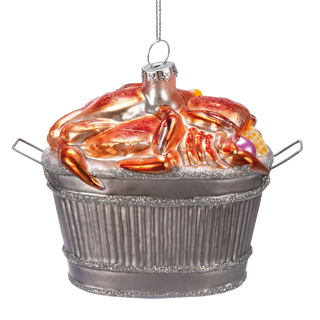 Glass crab bushel ornament angled to show the basket handles and the crabs spilling over the rim, white background