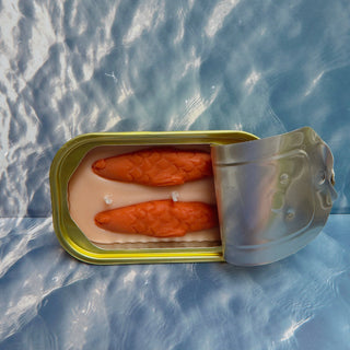 Amber soy candle peel-back lid reveal, hand-illustrated coral fish-tin scene inside