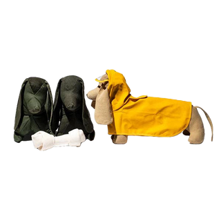 Olive green Puebco fabric dog stuffed animal styled in a home setting