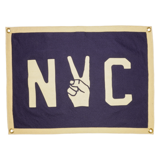 NYC peace pennant in navy wool felt with cream lettering and border, the Y formed by a peace-sign hand, with corner grommets
