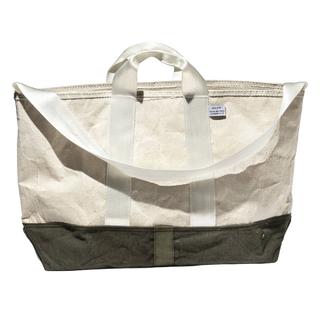 The tote shown from above with its mouth open, revealing the wide unlined interior and the straps running down the sides