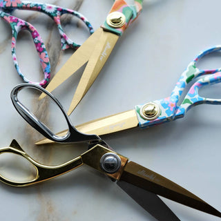 Pair of scissors with floral handles on a light background
