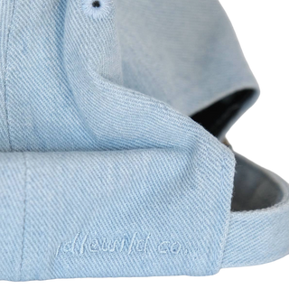 Underside of the cap brim with idlewild co. embroidered in tonal light blue thread